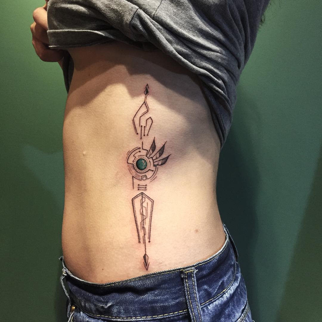 Minimalist cyberpunk tattoo on side of torso, featuring geometric and futuristic design with a central circular element